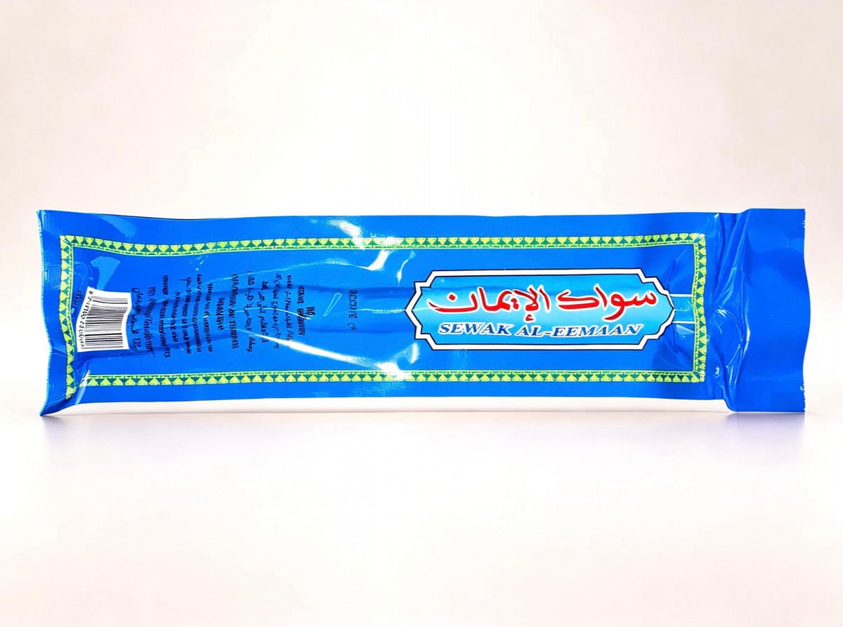 Blue Sewak Al-Emaan individual Miswak wrapper featuring Arabic product branding, English name and original packaging design.