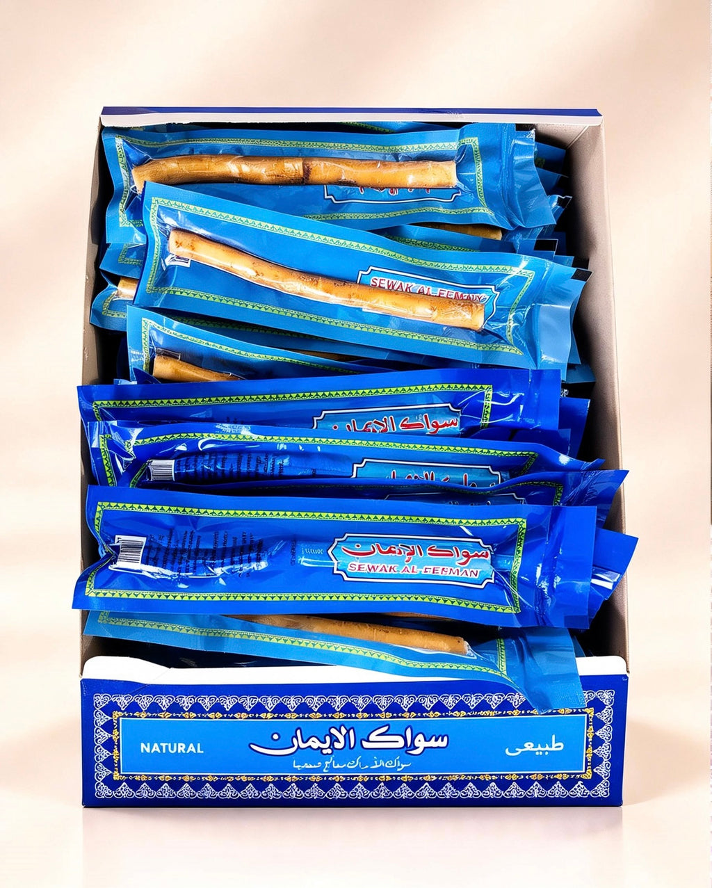 Close-up of Al-Emaan Sewak 60-piece retail box displaying individually wrapped natural Miswak sticks arranged inside.