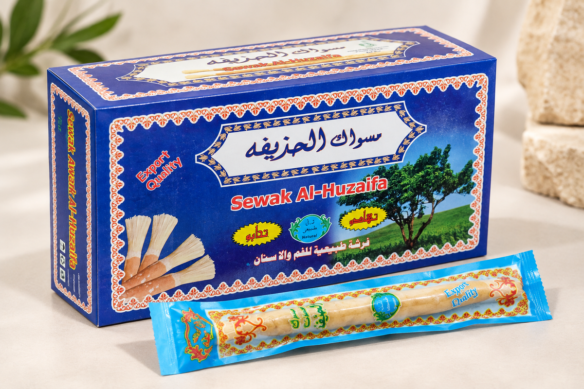 Angled three-quarter view of Sewak Al-Huzaifa 12 Pieces miswak box with one wrapped miswak stick.